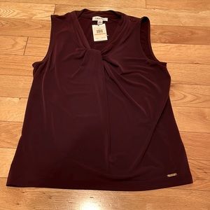 Women burgundy top never worn .